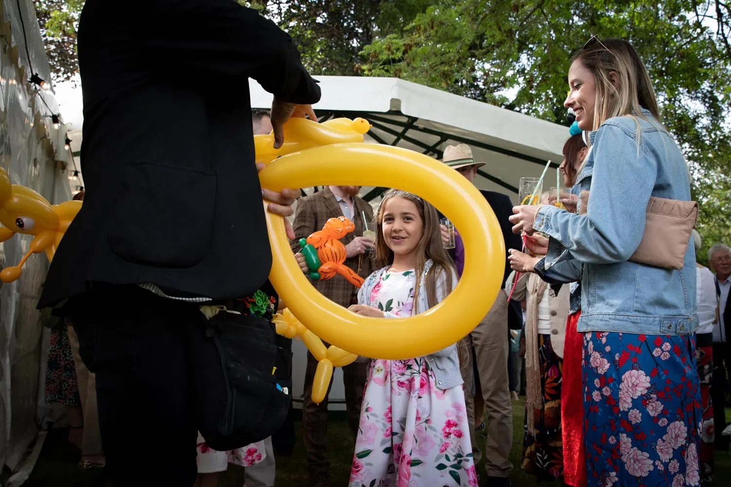 Balloon modeller creating a balloon sculpture for a guest