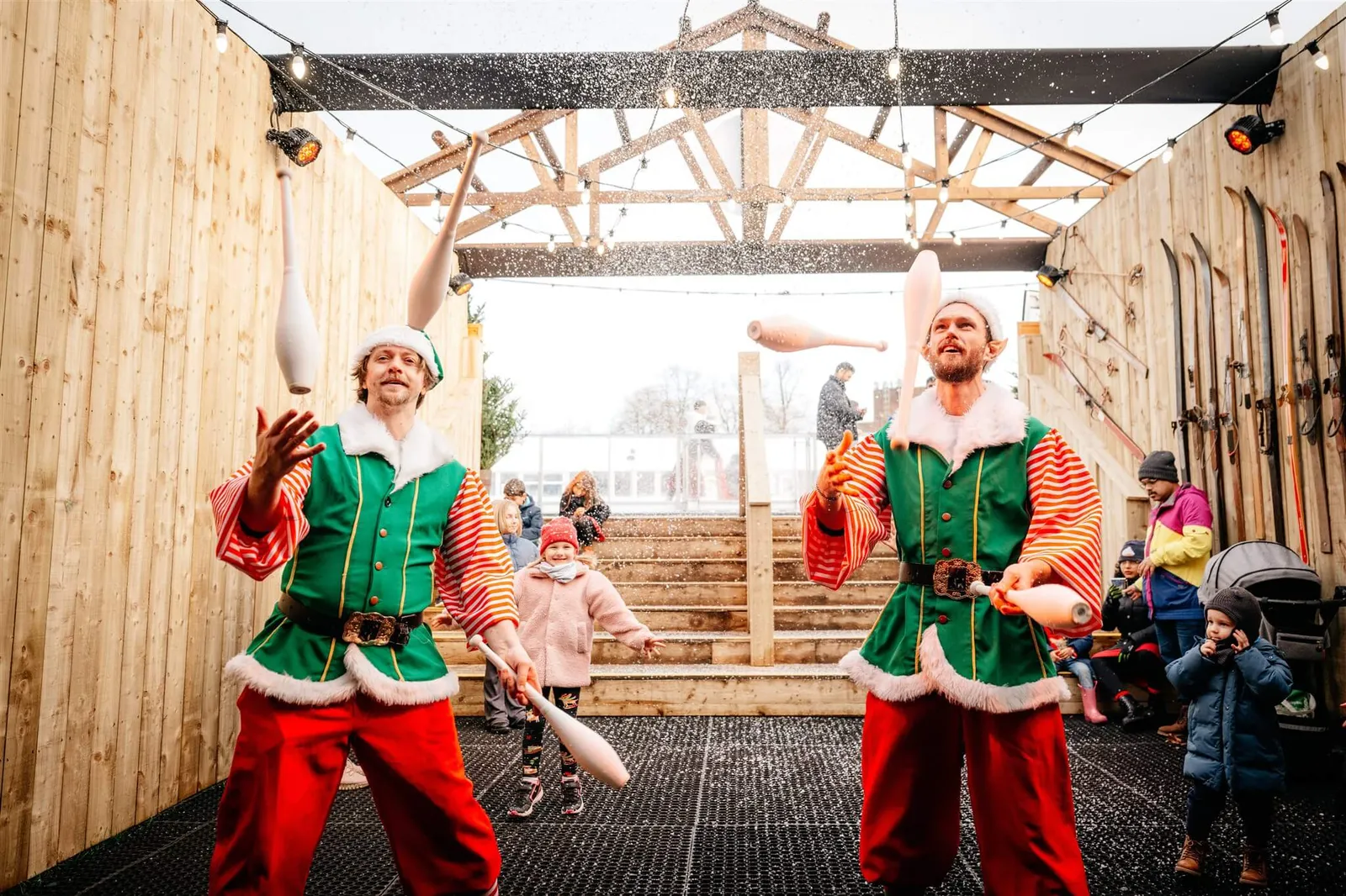 Festive elf characters performing at a Christmas event