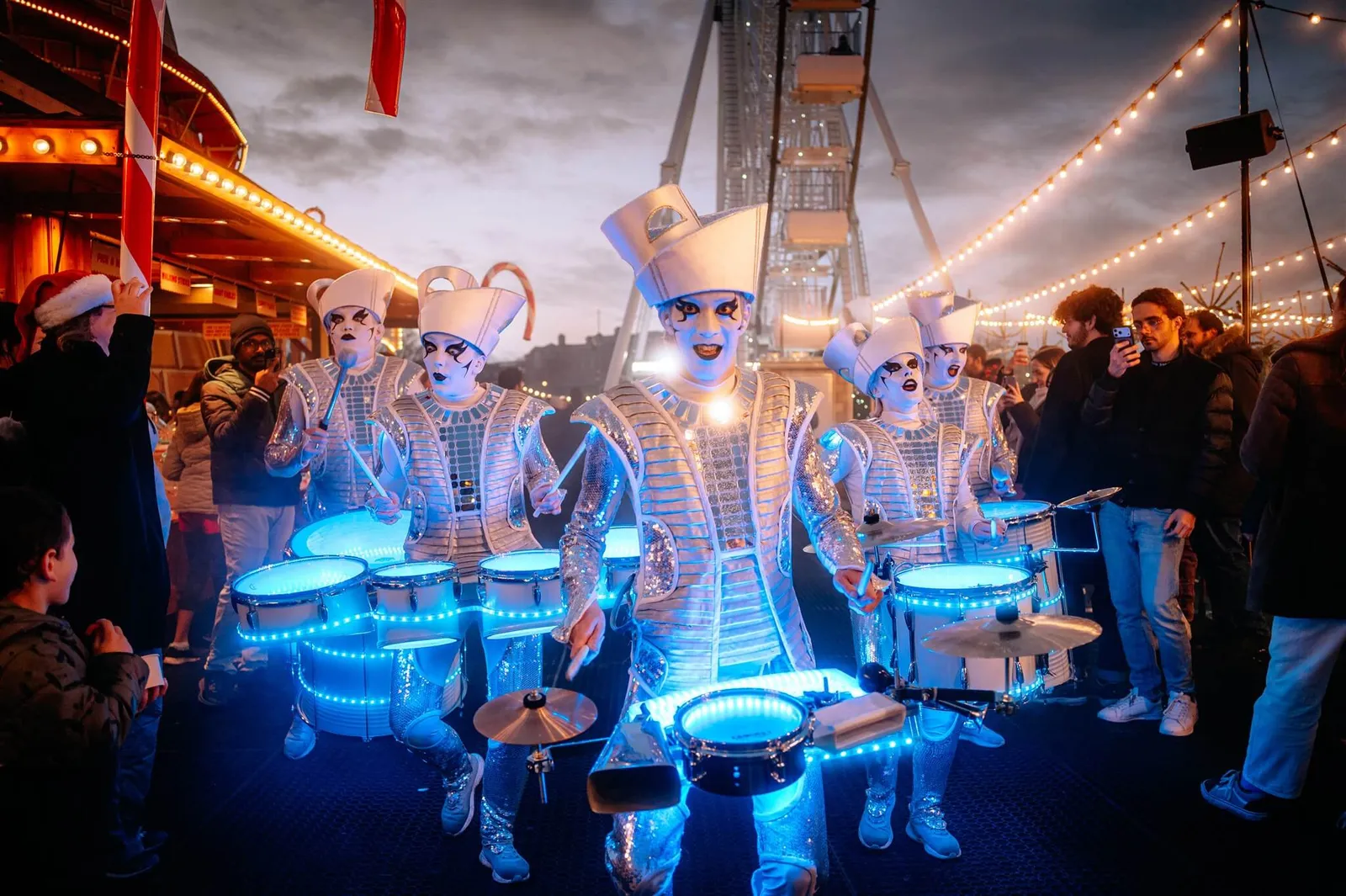 Light-up drum band performing as the afternoon light fades