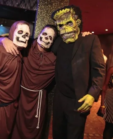 Costumed monster walkabout character posing with guests at a horror themed night