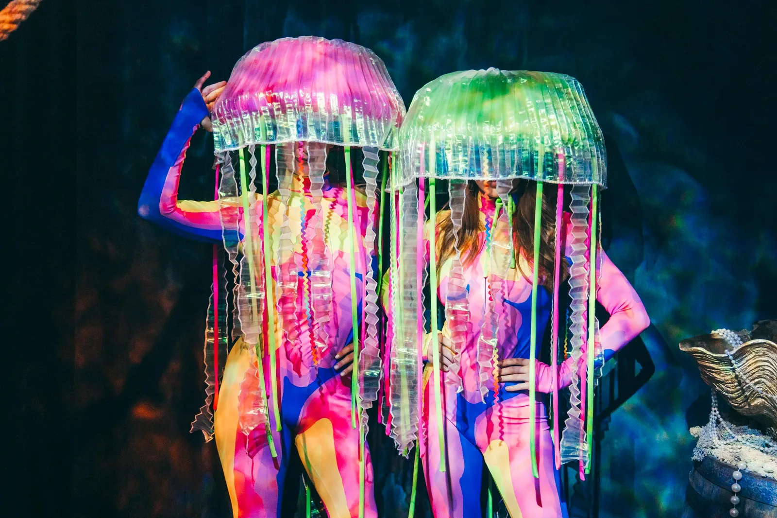 UV neon jellyfish dancers glowing in a dark show space