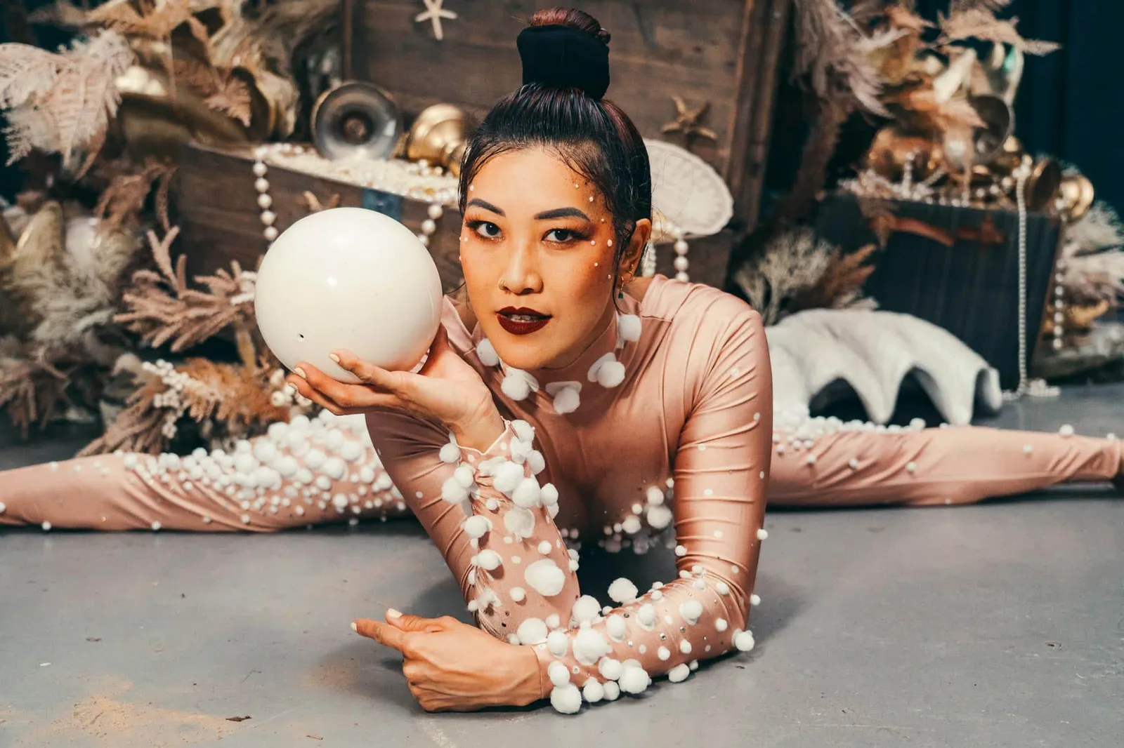 Pearl-themed rhythmic gymnast performing with a ball