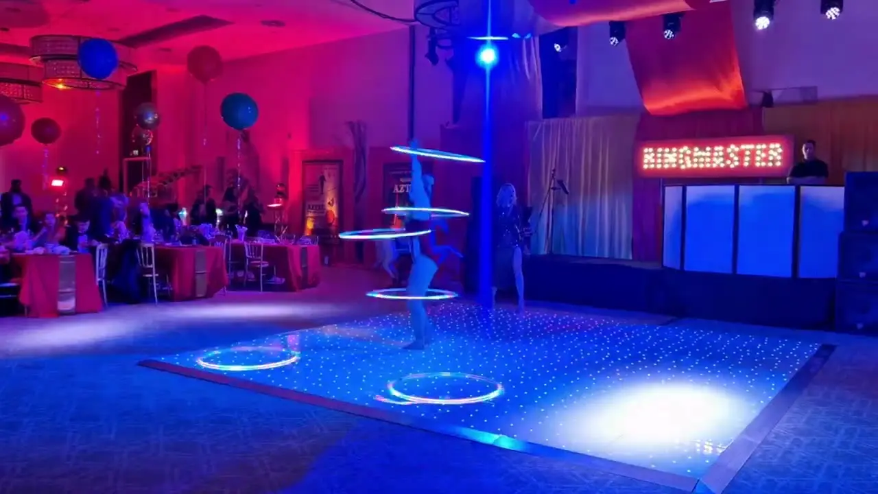 Singer with live circus performers: circus acts, circus showman theme