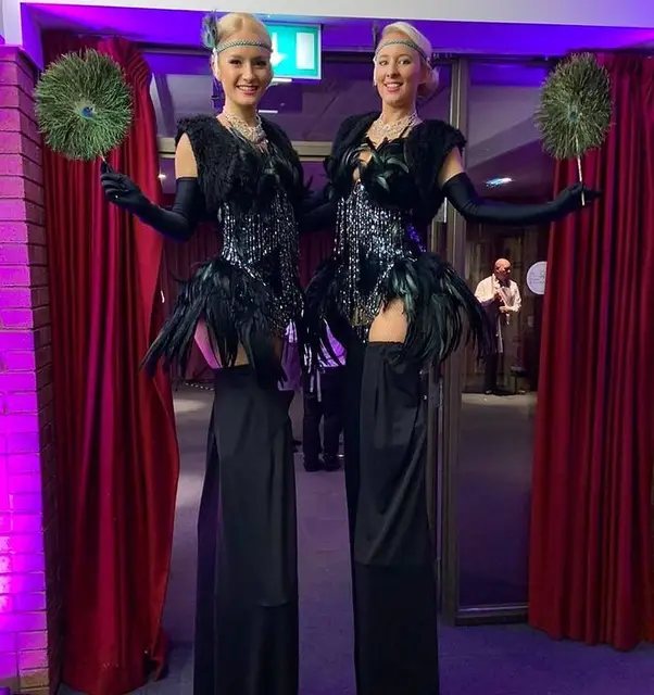 Black showgirl Gatsby peacock feather stilt 1920s: stilt walkers, gatsby theme