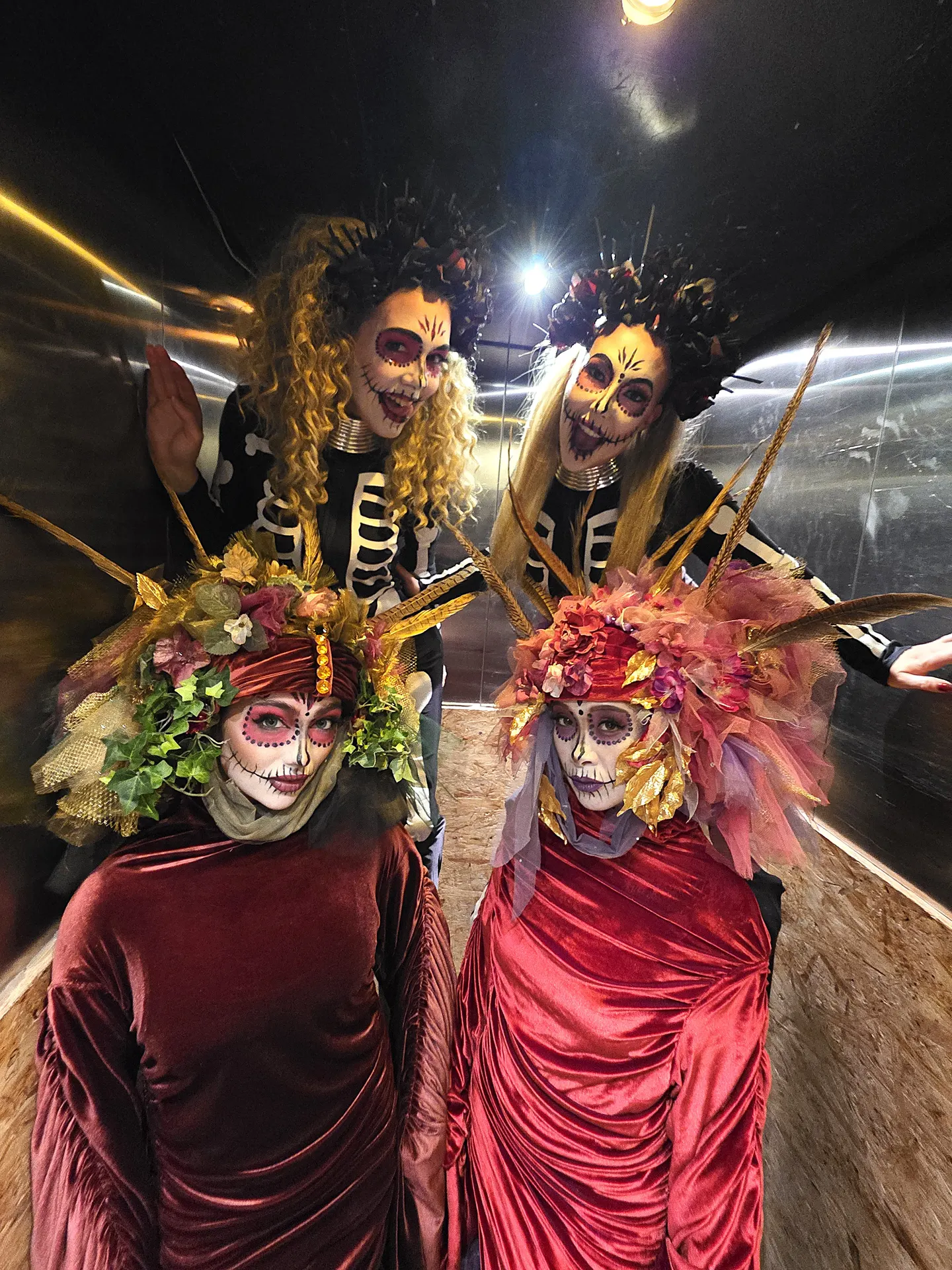 Floral venetians day of the dead with stilt skeletons: living statues